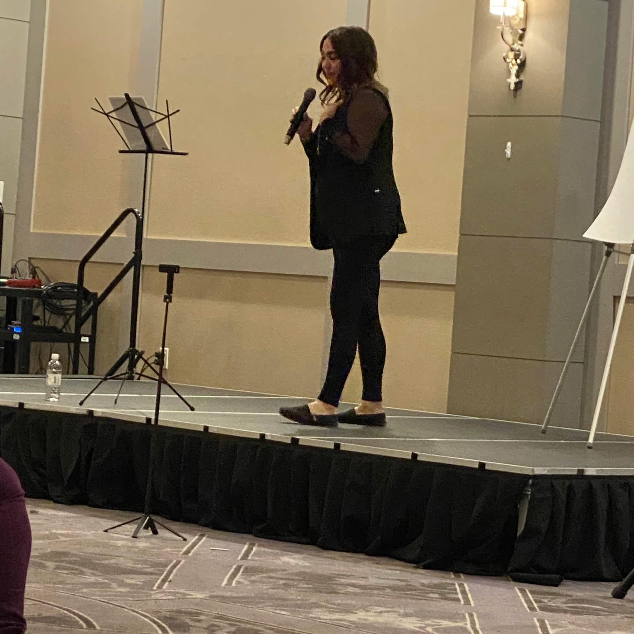 Christine speaking on stage