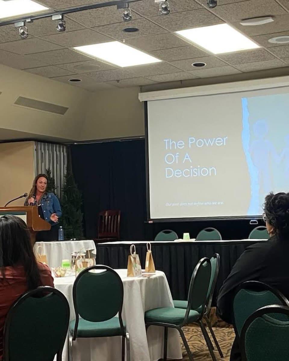 Christine speaking with 'The Power of a Decision' slide